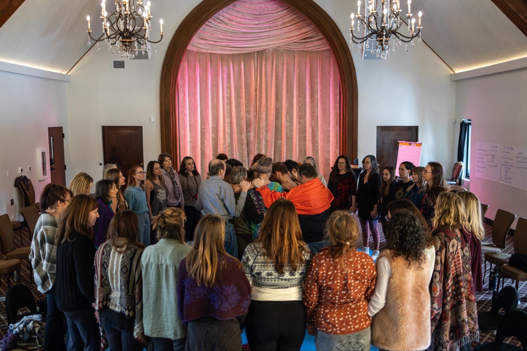 A circle gathering closely around deep work in the middle of the room