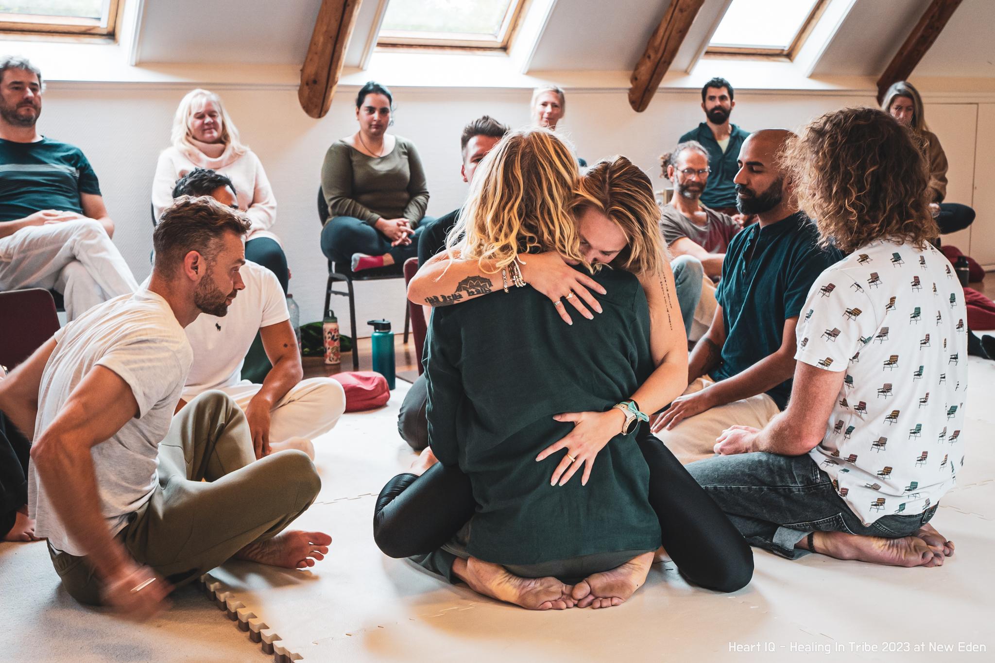 Two participants held by the circle inside Healing in Tribe