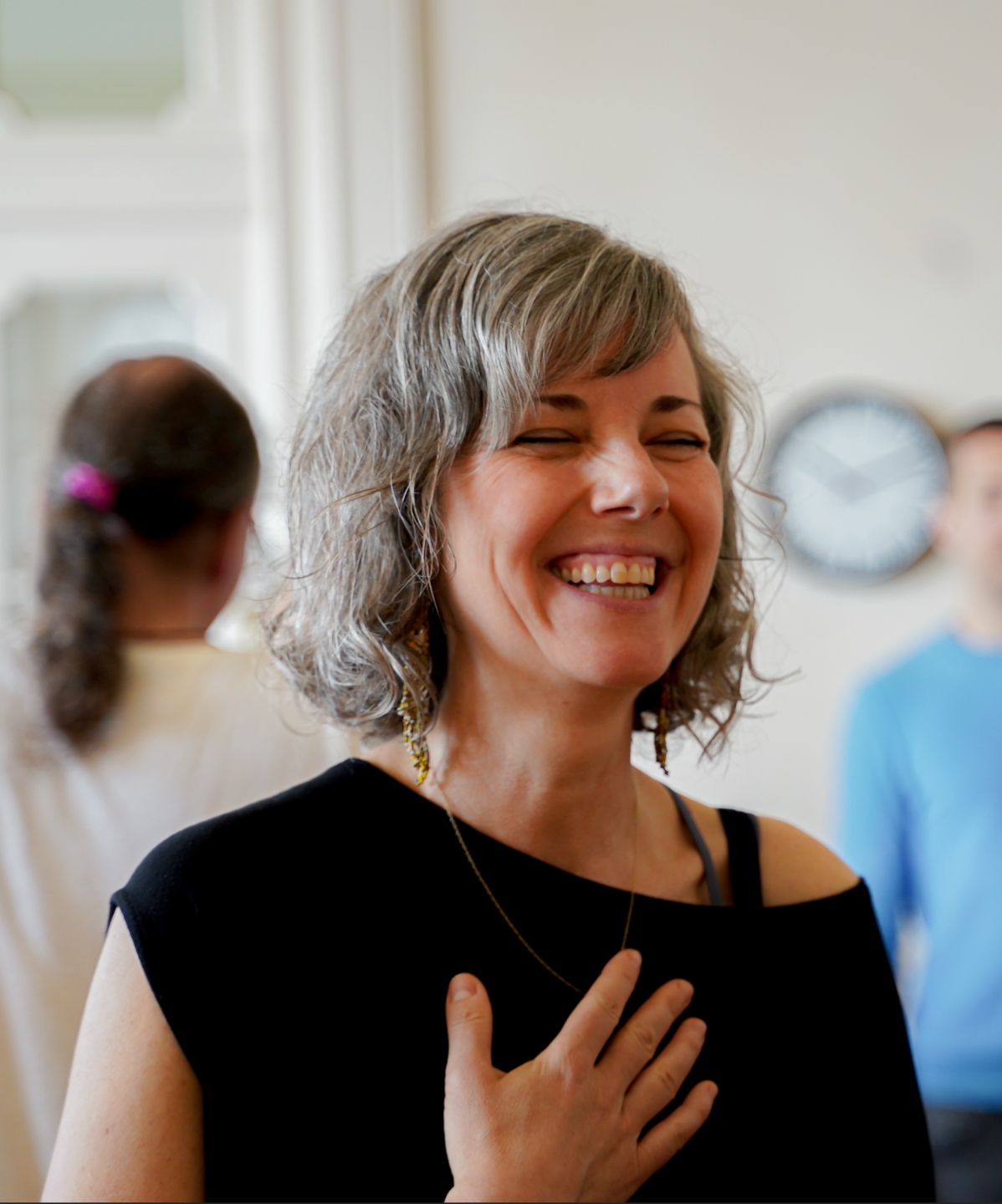 A joyful Heart iQ participant with her hand on her heart